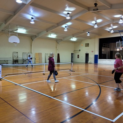 CCOSDD gymnasium showing BB goals and pickleball players