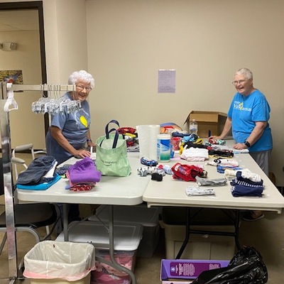 Volunteers sorting/sizing clothing